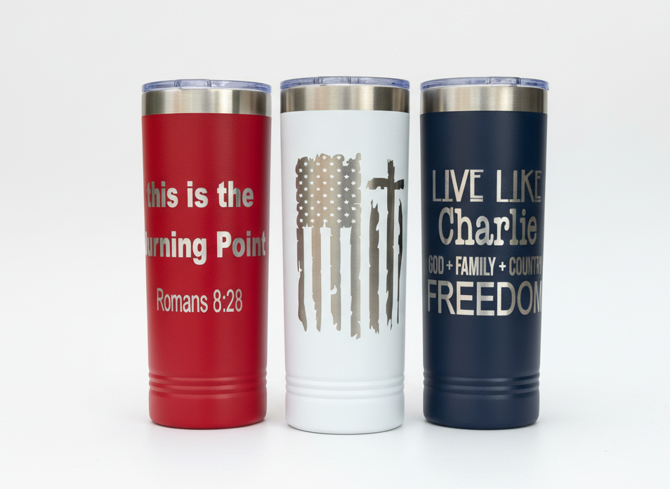 22oz skinny tumblers in red white and blue with an engraved flag with a cross and 2 different phrases honoring Charlie Kirk