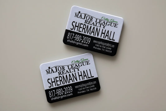 Two custom business cards for a Realtor with contact information uv printed with texture on a magnet material