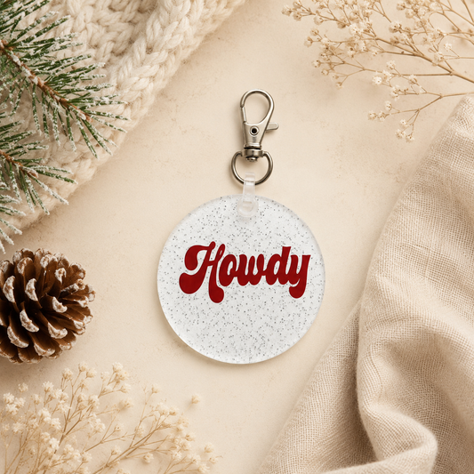 Round keychain with 'Howdy' text on a textured surface with decorative elements