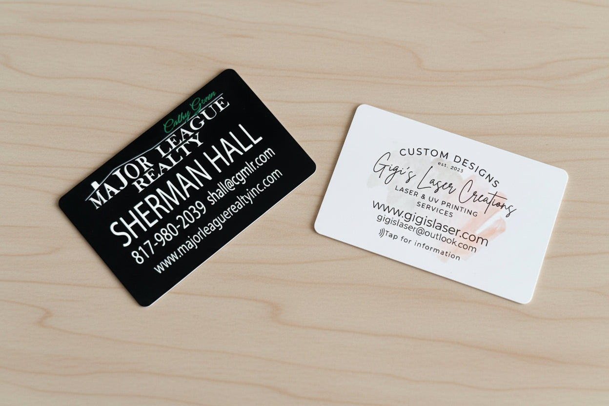Two NFC enabled business cards on a textured surface, one black and one white. This allows you to network by client simply taps your business card and they can download your virtual business card. 