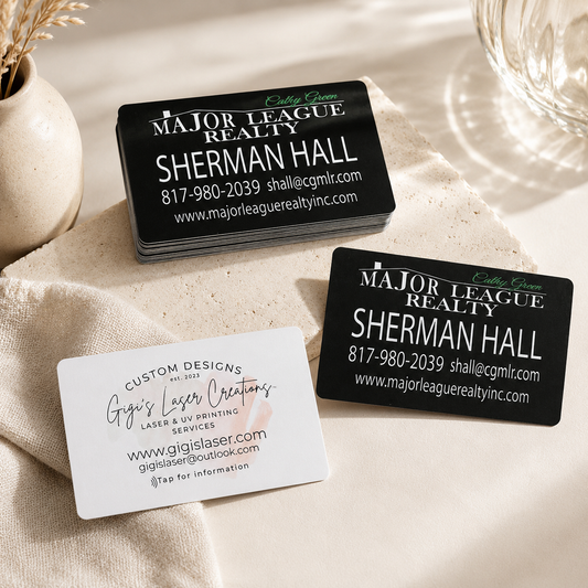 Two business cards for Major League Realty with contact information on a beige surface.