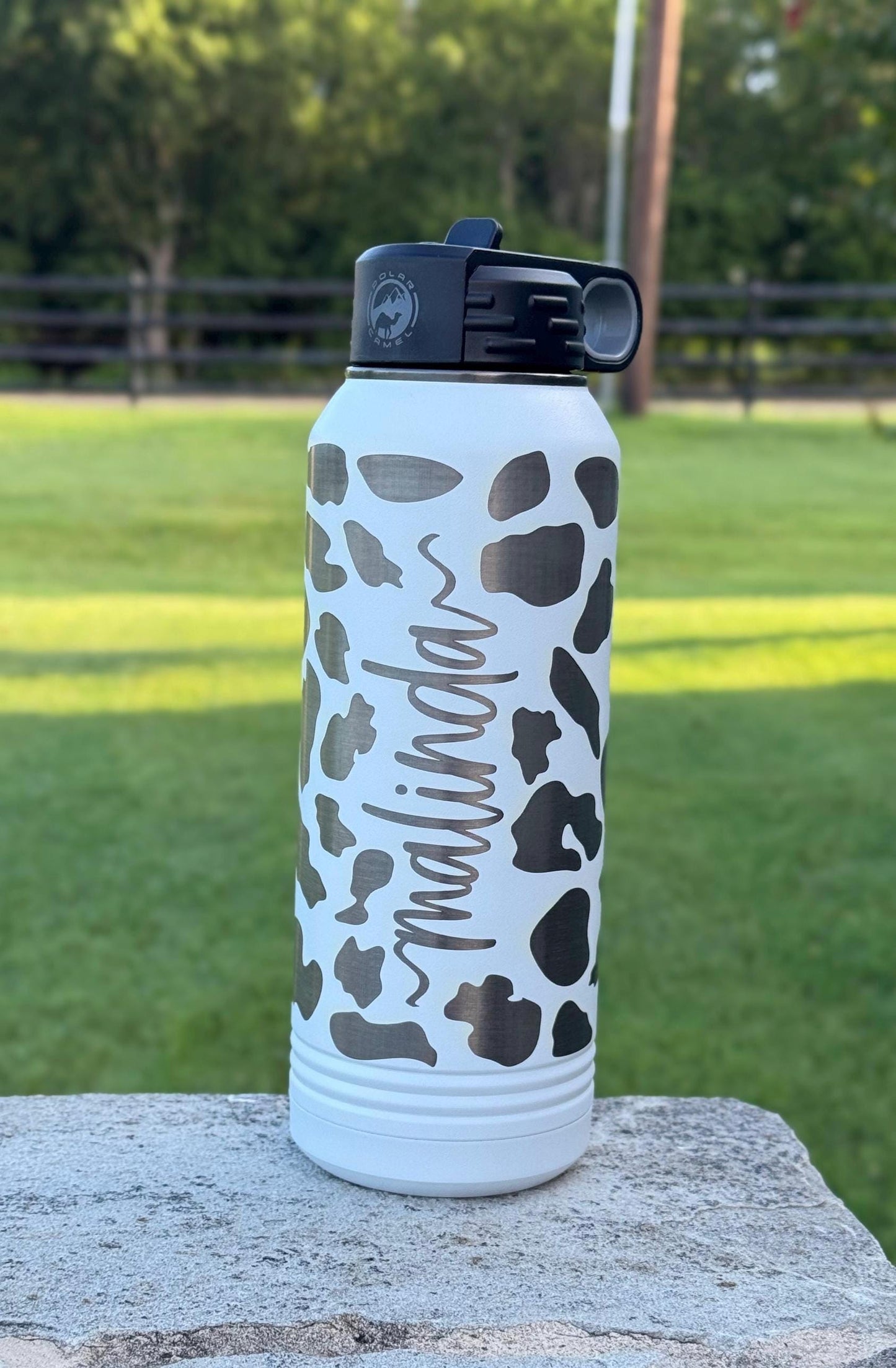 Cow print water bottle showing available sizes for personalized western gifts